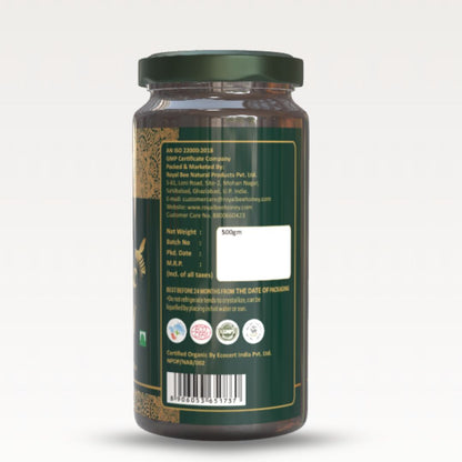 Back view of a green jar with text and certification logos on a white background